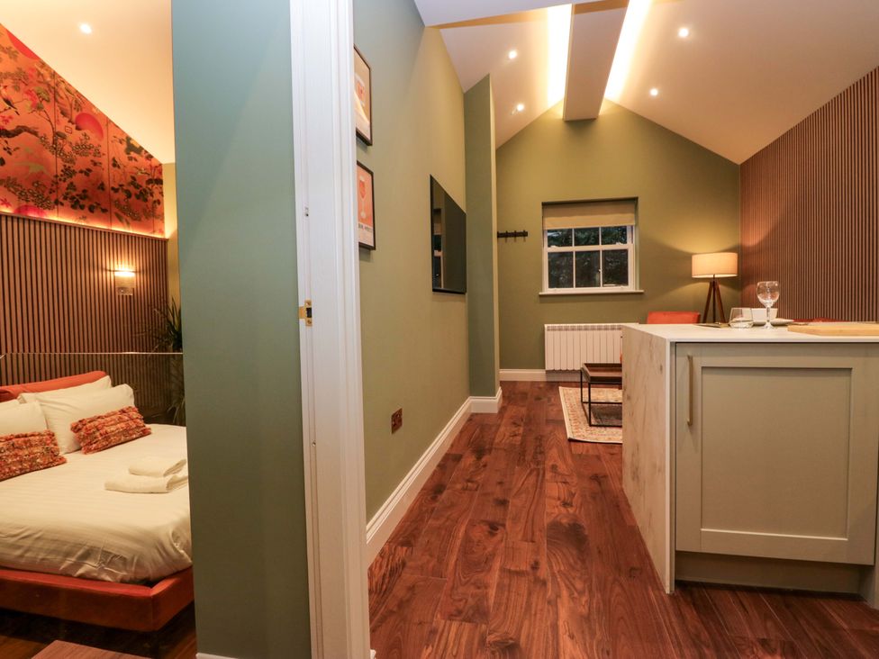 A studio with a bed and television at The Studio in Windermere