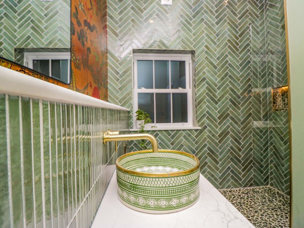 A bathroom with a sink and window at The Studio in Windermere