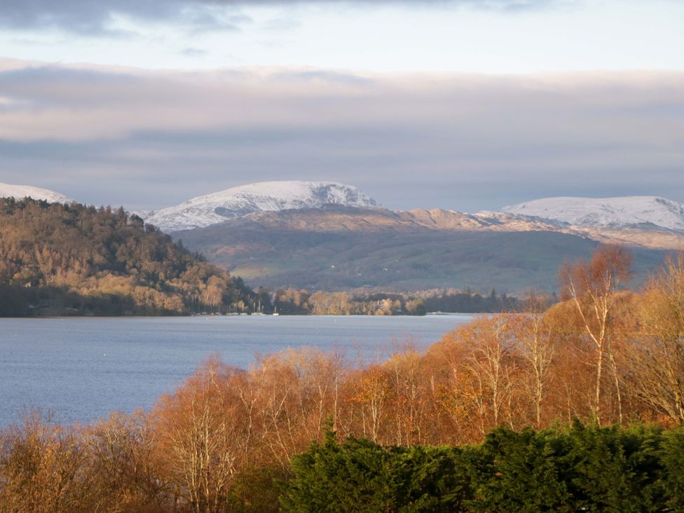 A view of a lake with mountains and trees at The Studio in Windermere