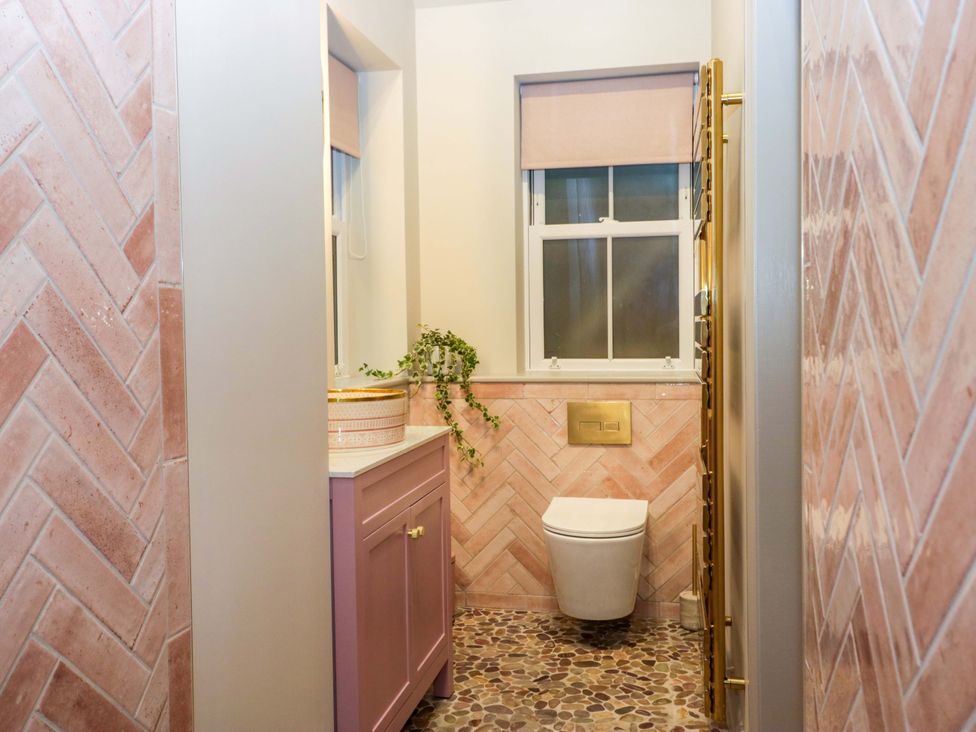 A bathroom with a toilet and sink at The Coach House in Windermere