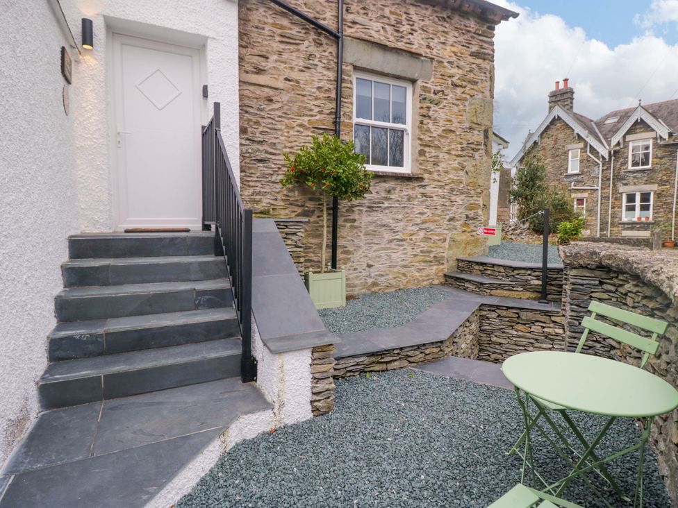 An outdoor area with steps and a table at The Coach House in Bowness-On-Windermere