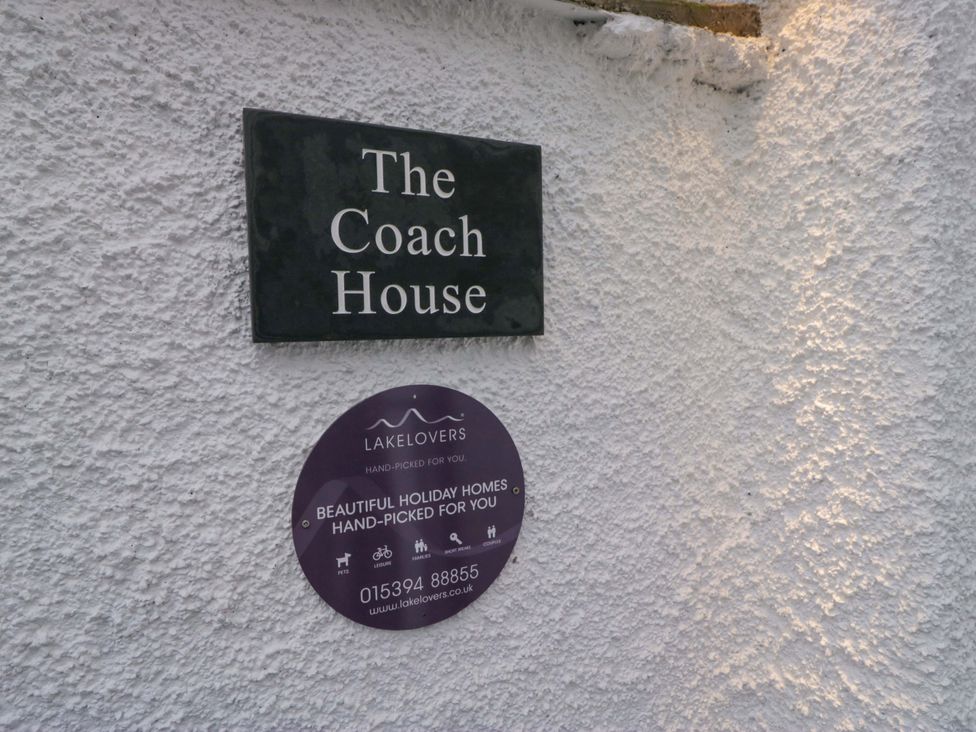 A property name sign and holiday home plaque at The Coach House in Bowness-On-Windermere