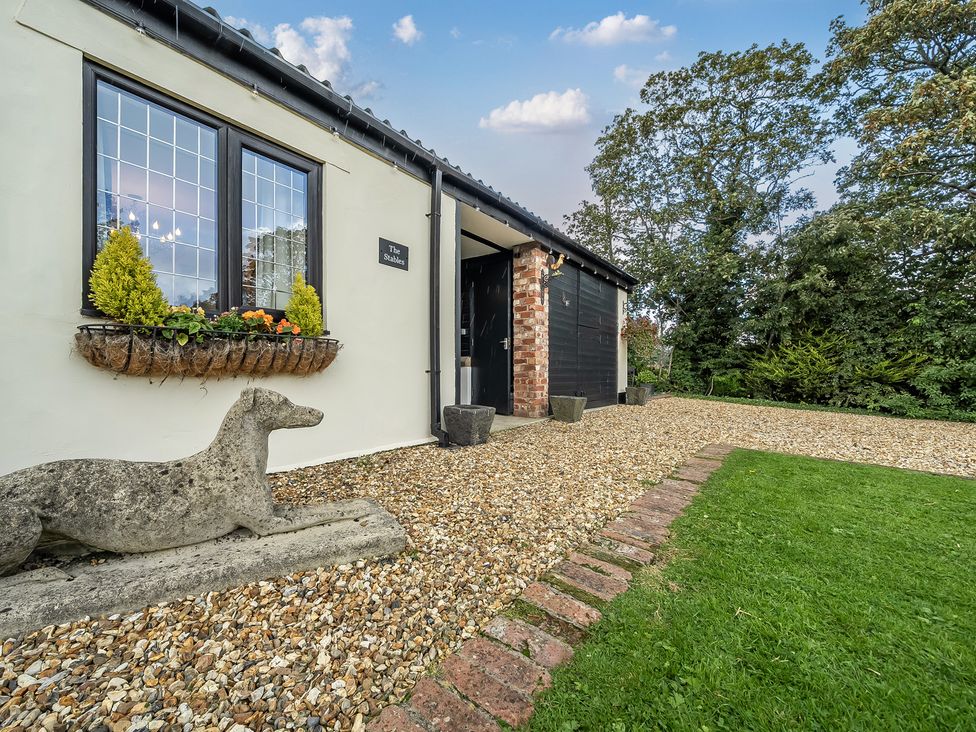 An outdoor view of a property entrance with a stone dog statue at The Stables in Poulton-le-Fylde