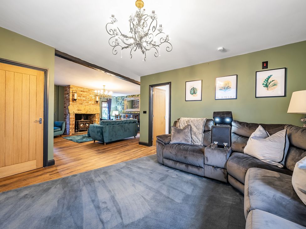 A living room with a sofa and light fixture at The Stables in Poulton-le-Fylde