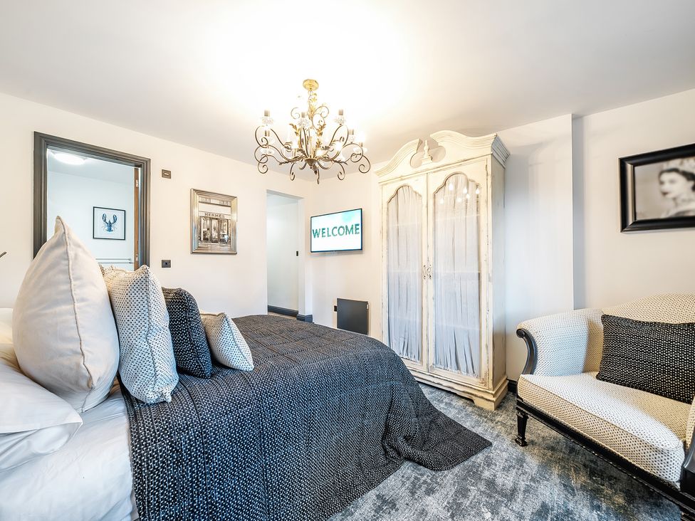 A bedroom with a bed and a TV at The Stables in Poulton-le-Fylde