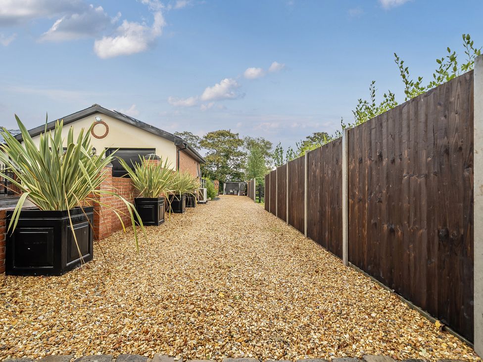 An outdoor area with gravel path and planters at The Stables in Poulton-le-Fylde
