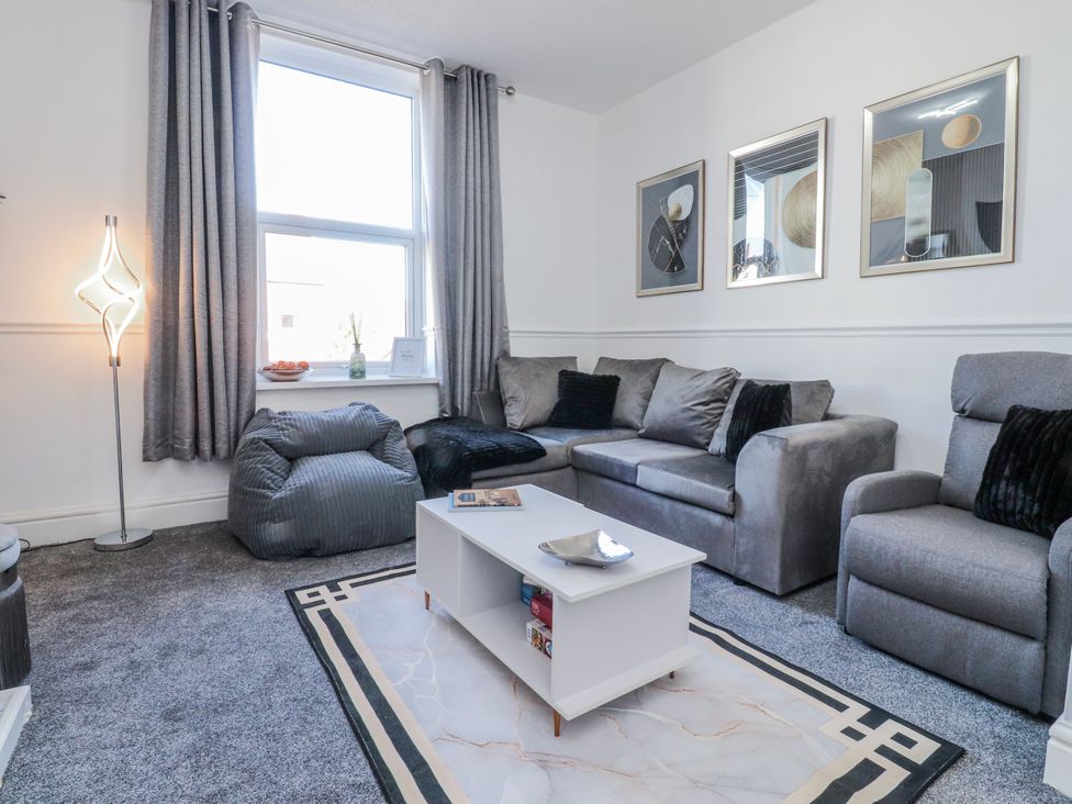 A living room with a sofa and coffee table at Bliss in Lytham St. Annes