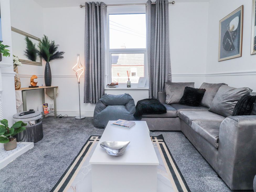 A living room with a sofa and coffee table at Bliss in Lytham St. Annes
