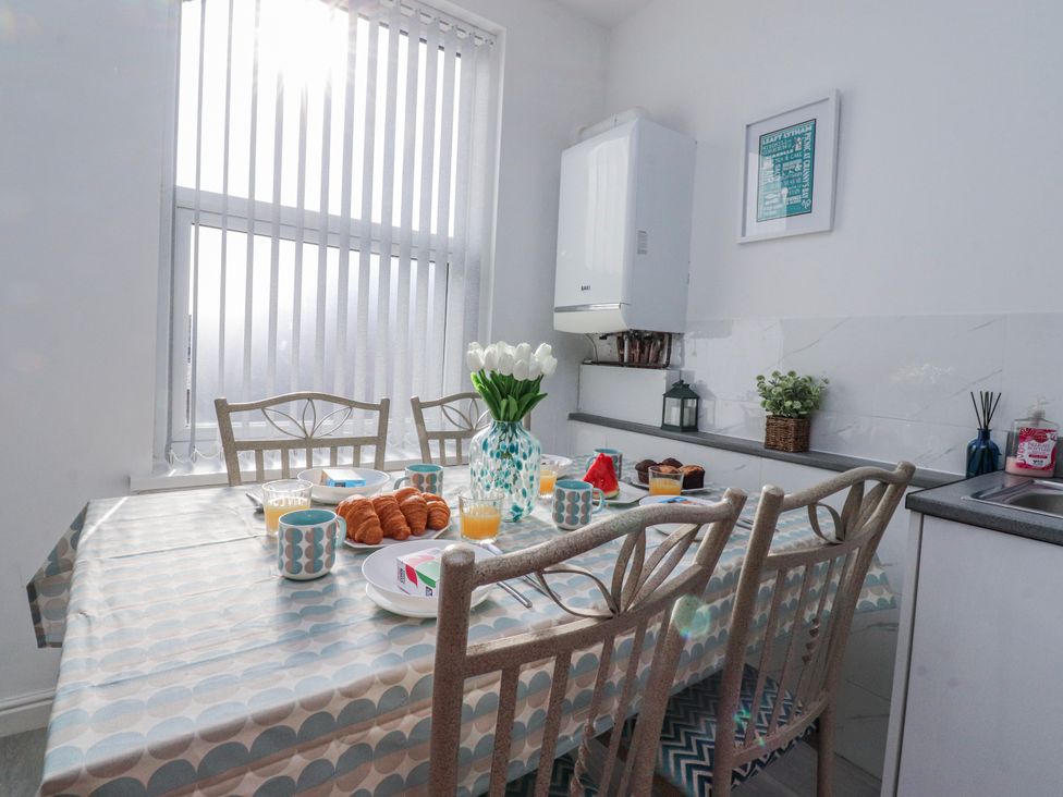 A kitchen with a dining table and breakfast items at Bliss in Lytham St. Annes