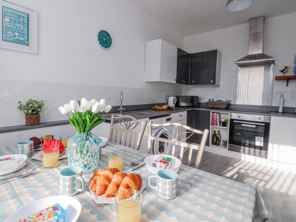 A kitchen with a dining table and croissants at Bliss in Lytham St. Annes