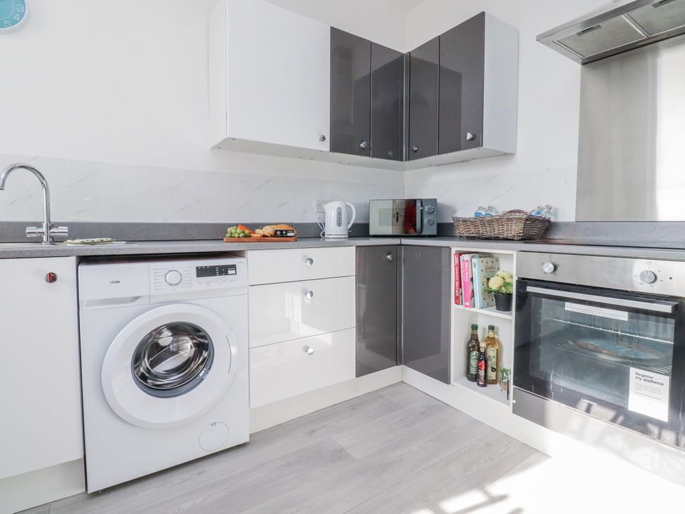 A kitchen with appliances and storage at Bliss in Lytham St. Annes