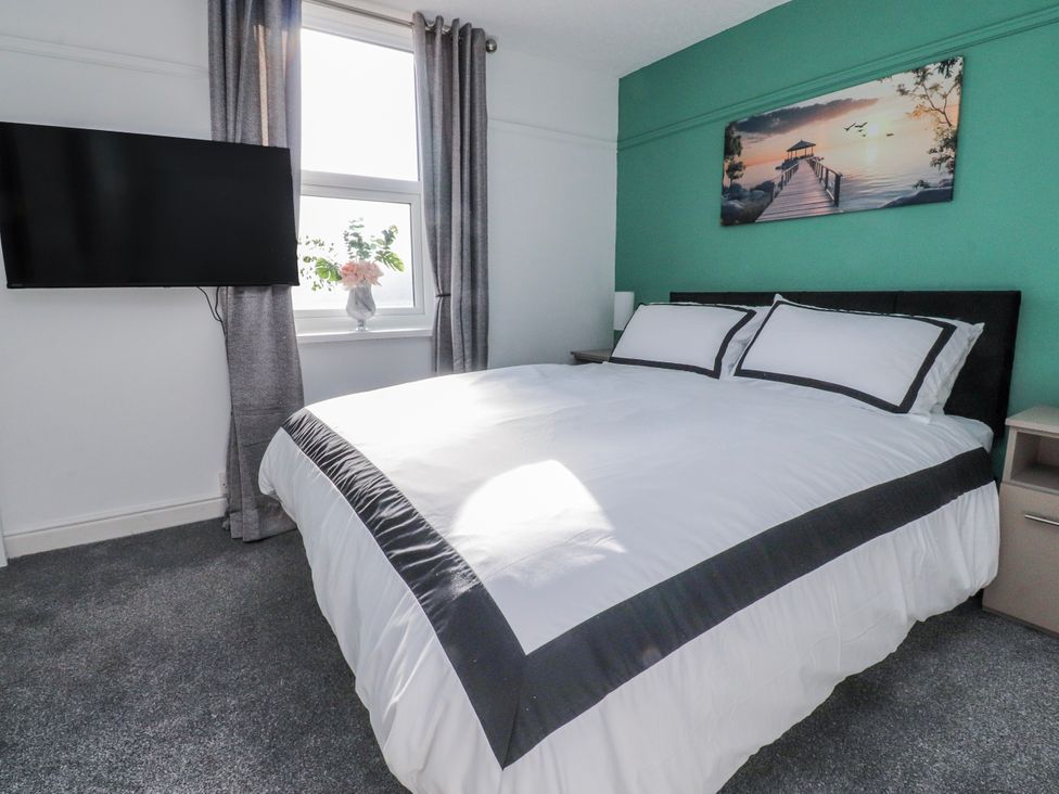 A bedroom with a bed and a television at Bliss in Lytham St. Annes