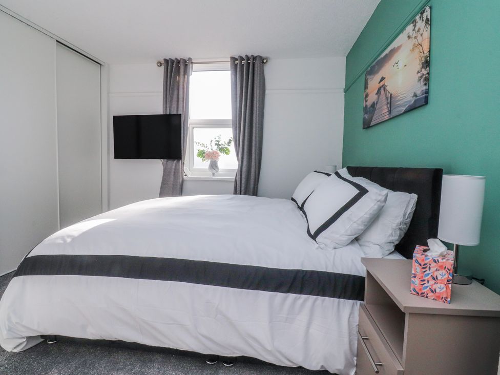 A bedroom with a bed and television at Bliss in Lytham St. Annes