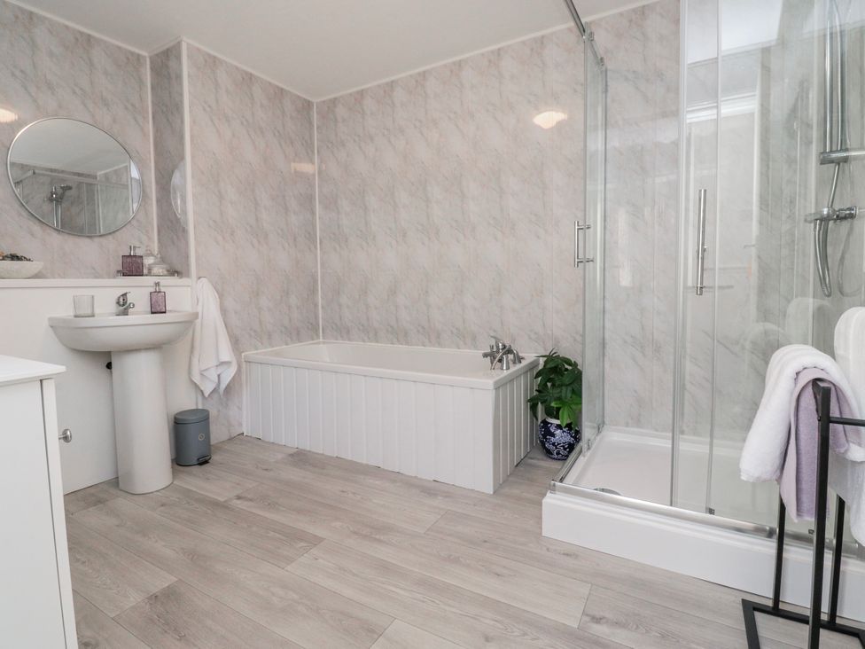 A bathroom with a bathtub, shower, sink, and mirror at Bliss in Lytham St. Annes