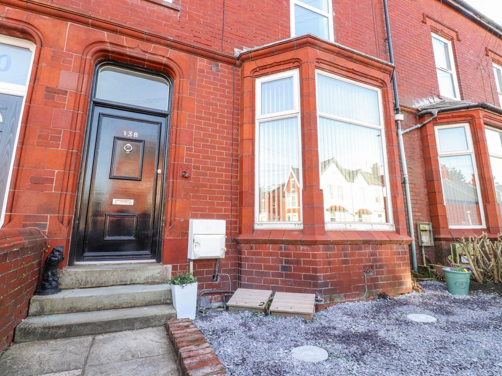 An entrance with a black door and large windows at Bliss in Lytham St. Annes