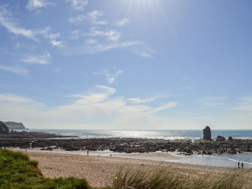 A beach with rocky formations and ocean at 8 Thurlestone Rock in Kingsbridge