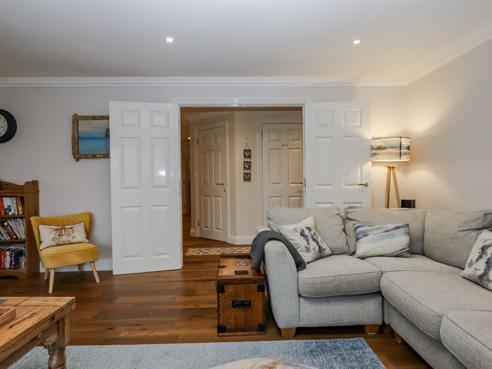 A living room with a sofa and coffee table at 8 Thurlestone Rock in Kingsbridge