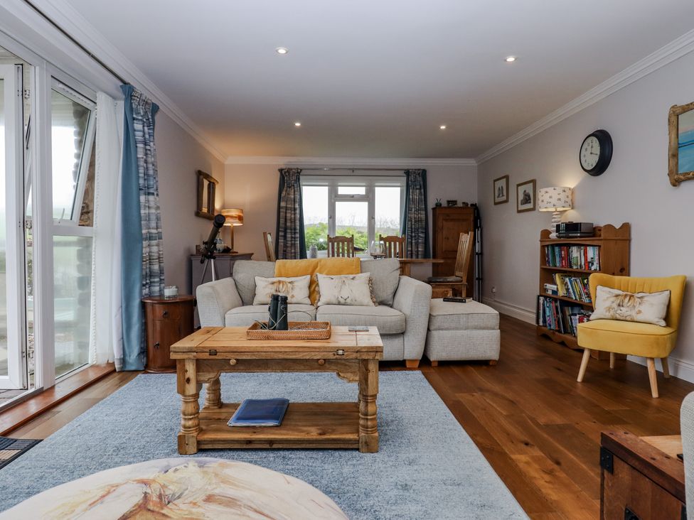 A living room with a sofa and coffee table at 8 Thurlestone Rock in Kingsbridge
