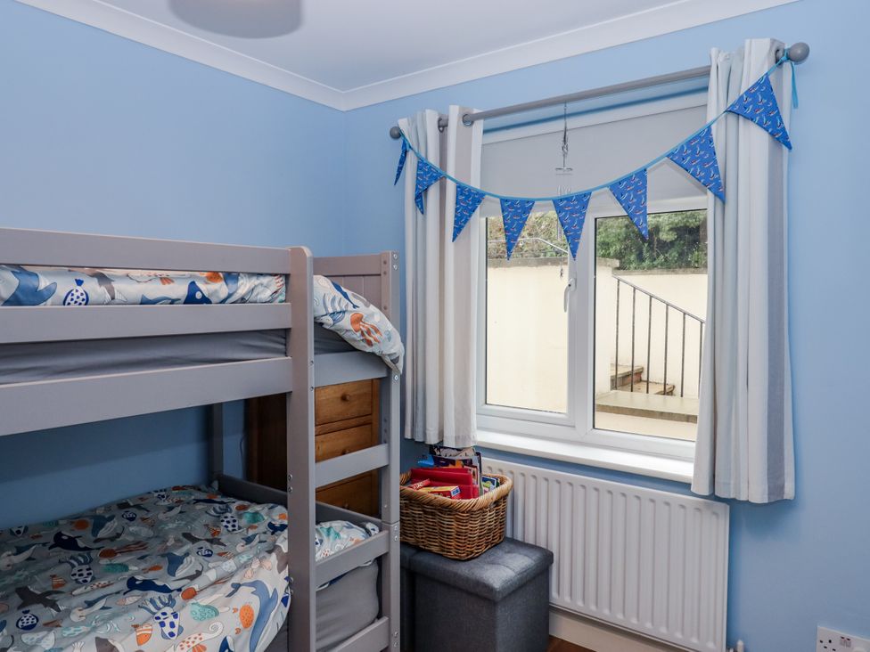 A bedroom with a bunk bed and window at 8 Thurlestone Rock in Kingsbridge