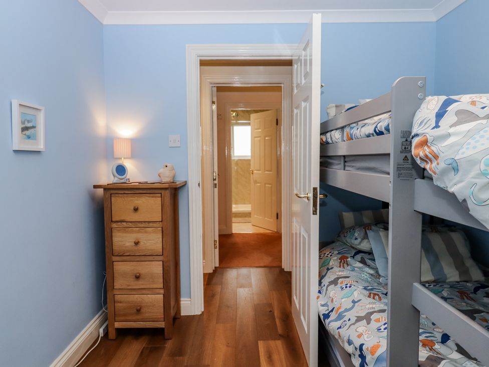 A bedroom with a bunk bed and nightstand at 8 Thurlestone Rock in Kingsbridge