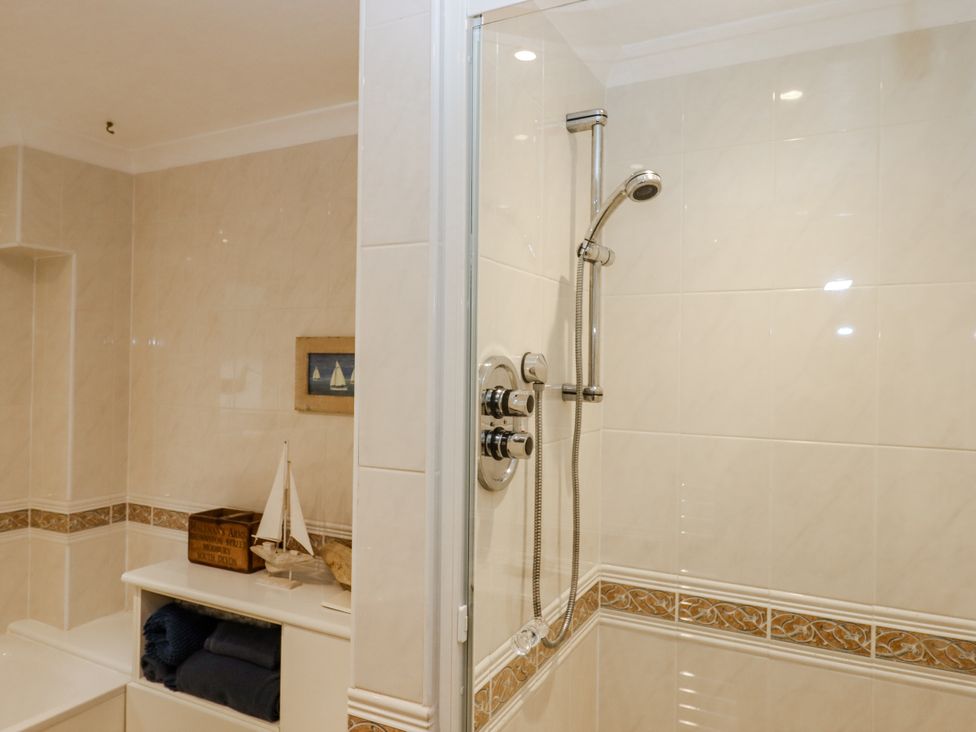 A bathroom with a shower and decorative items at 8 Thurlestone Rock in Kingsbridge