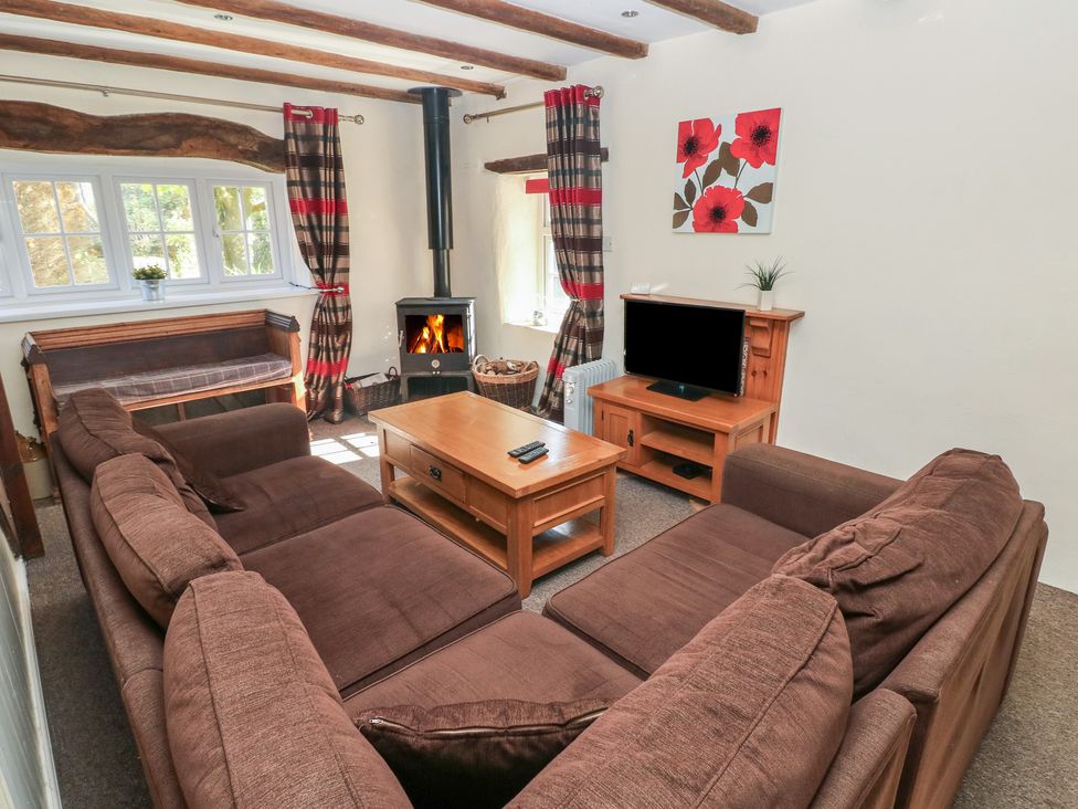A living room with a sofa and television at Carthouse Cottage in Clarbeston Road