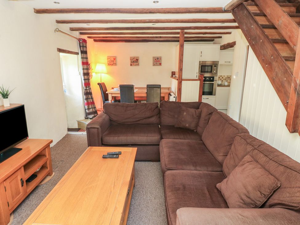 A living room with a sofa and coffee table at Carthouse Cottage in Clarbeston Road