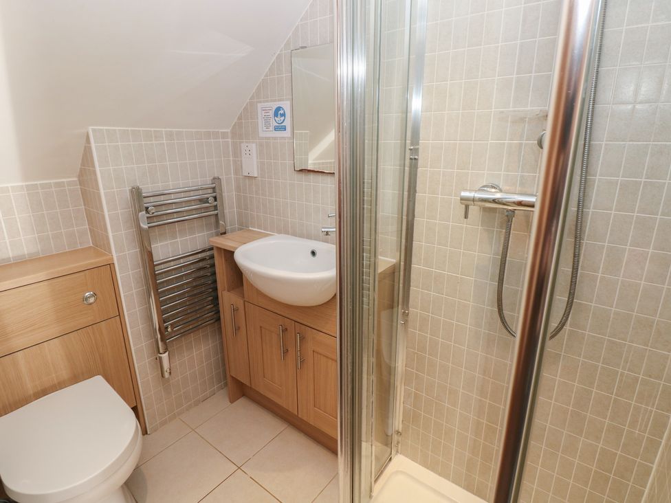 A bathroom with a shower and wash basin at Carthouse Cottage in Clarbeston Road