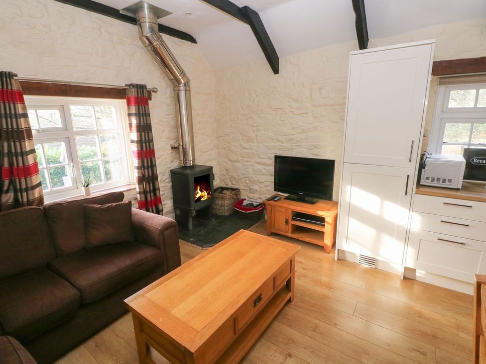 A living room with a coffee table and sofa at Knap Cottage in Clarbeston Road