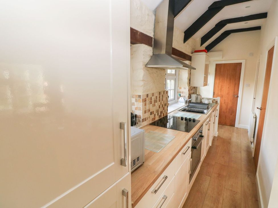 A kitchen with cabinets and a stove at Knap Cottage in Clarbeston Road