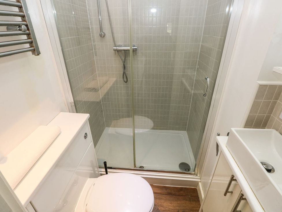 A bathroom with shower, toilet, and sink at Knap Cottage in Clarbeston Road