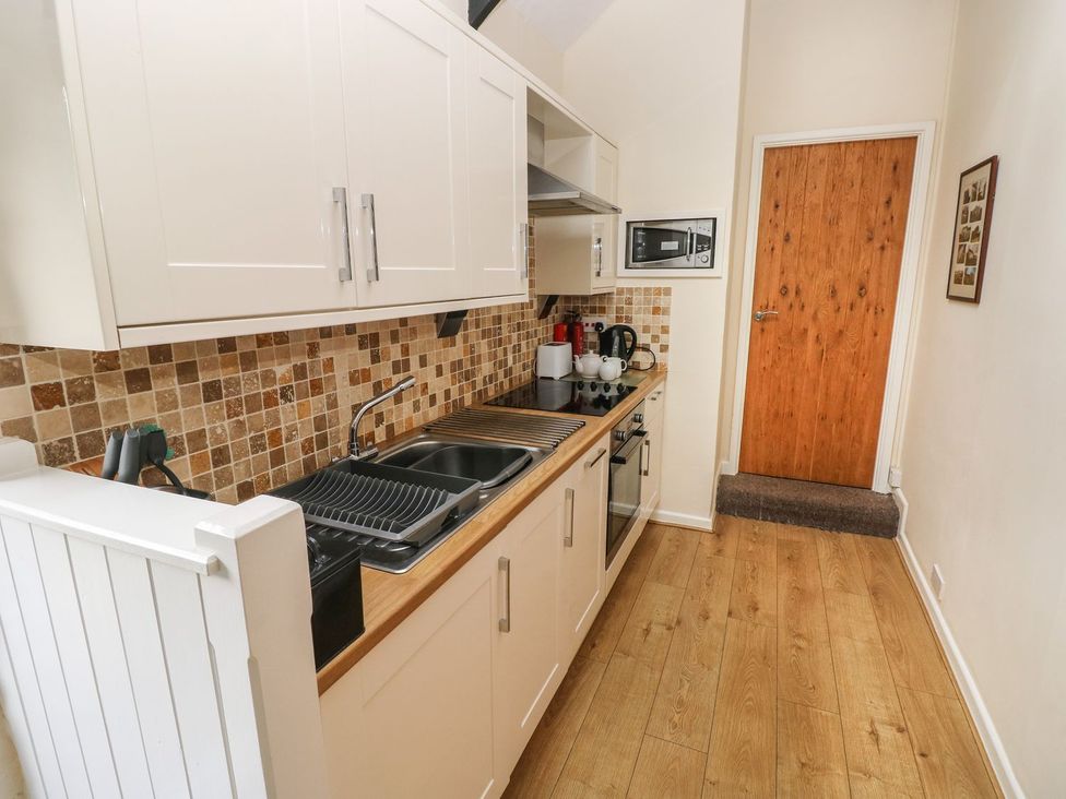 A kitchen with cabinets and appliances at Corner Cottage in Clarbeston Road