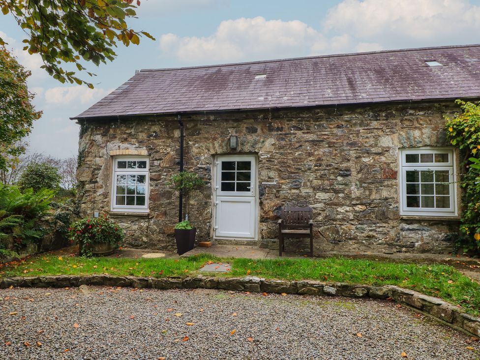 An exterior view of a stone cottage with a front door and windows at Shippen Cottage Clarbeston Road