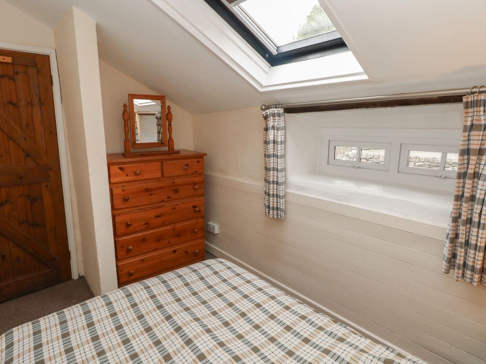 A bedroom with a dresser and mirror at Shippen Cottage Clarbeston Road