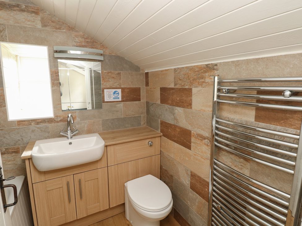 A bathroom with a sink, toilet, and towel radiator at Shippen Cottage Clarbeston Road