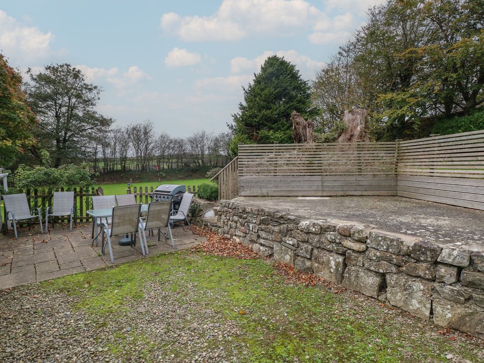 A garden with table and chairs and a grill at Shippen Cottage Clarbeston Road