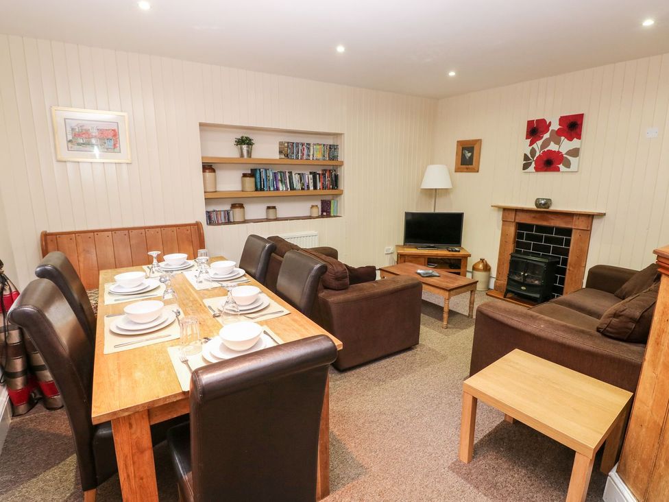 A dining room with a table and chairs at Lake Cottage in Clarbeston Road