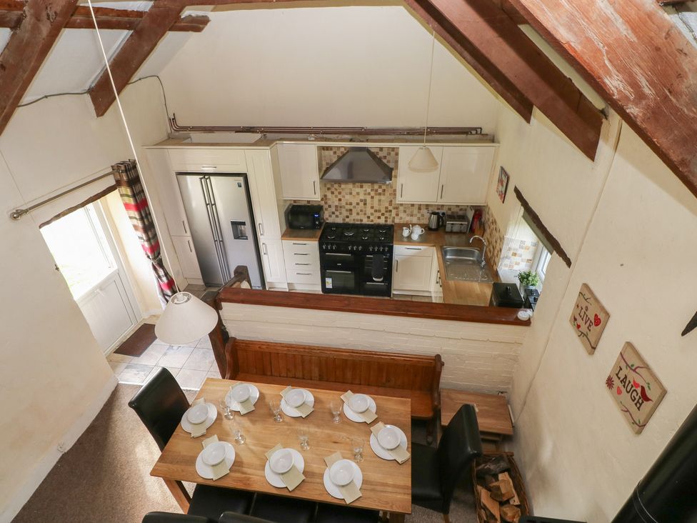 A kitchen with a dining table and chairs at Granary Cottage in Clarbeston Road