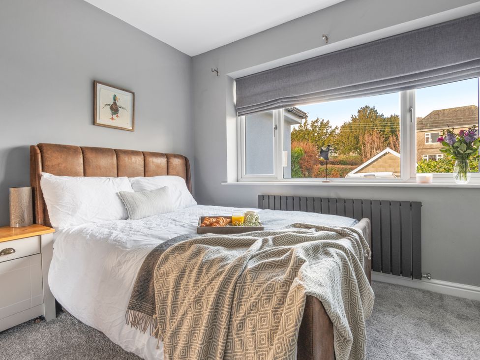 A bedroom with a bed and window at Newlands Yelverton