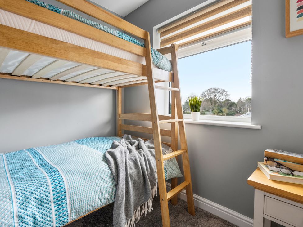 A bedroom with a bunk bed and window at Newlands Yelverton