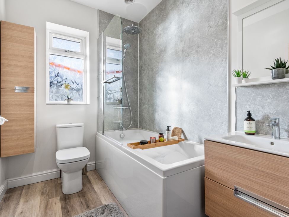 A bathroom with a bathtub and shower at Newlands in Yelverton