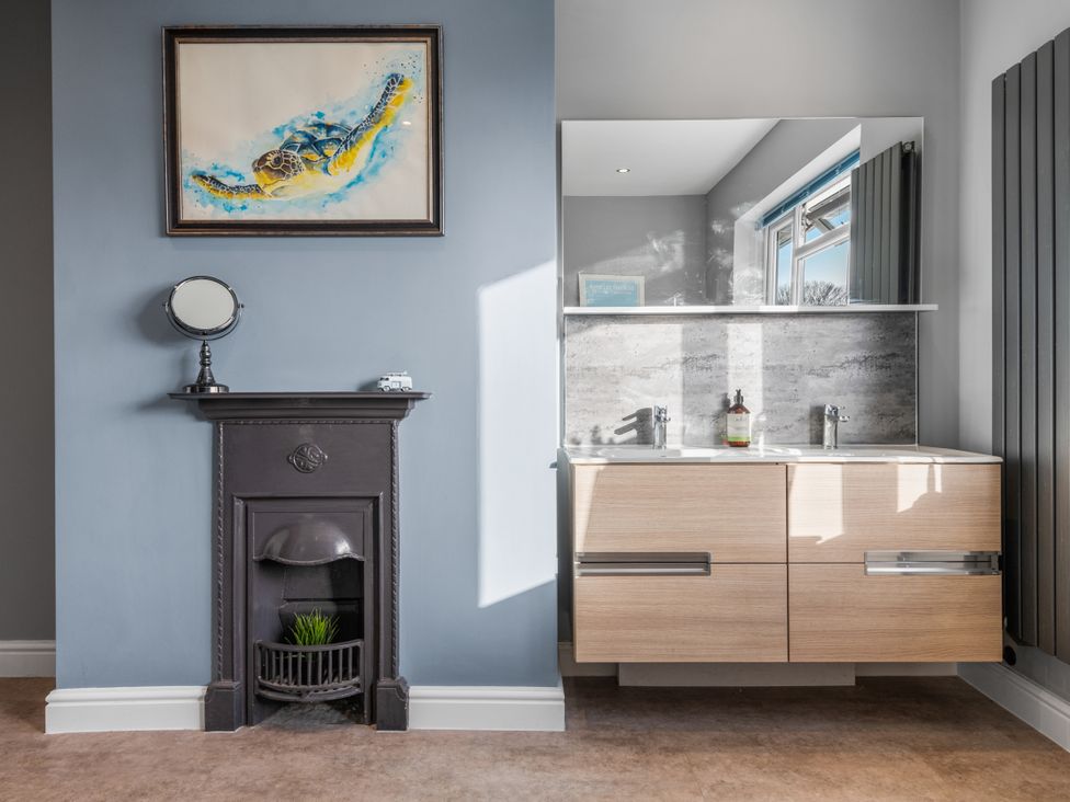 A bathroom with a sink and mirror at Newlands in Yelverton