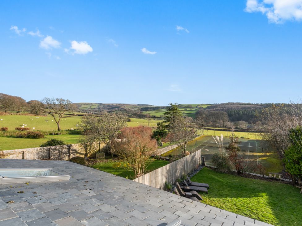 A view of fields and a tennis court at Newlands in Yelverton