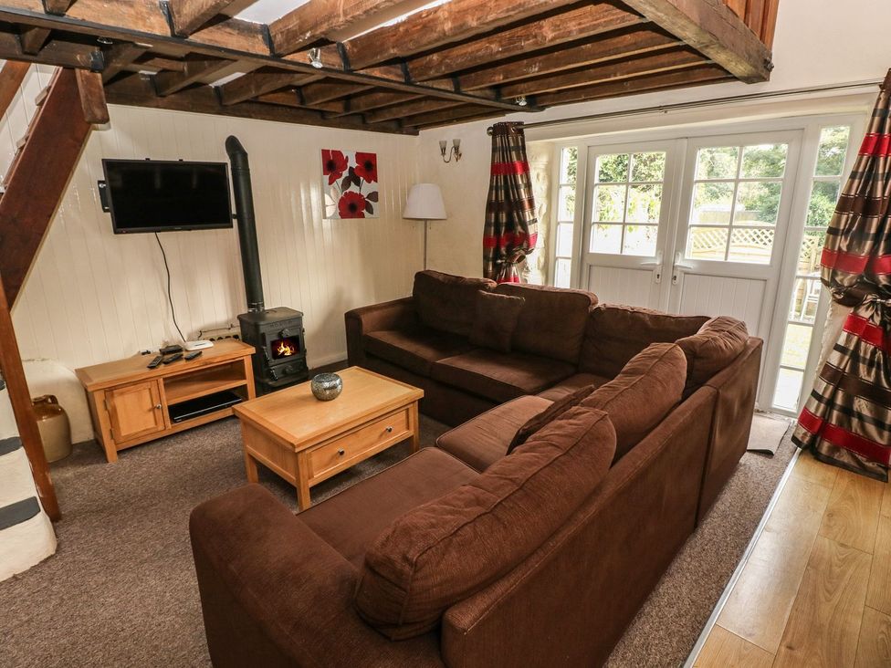 A living room with a sofa and coffee table at Rafters Cottage in Clarbeston Road