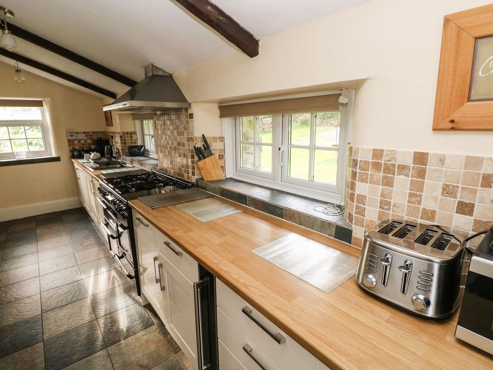 A kitchen with a stove and toaster at Rafters Cottage in Clarbeston Road
