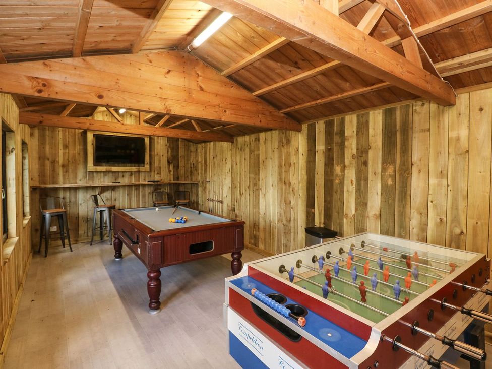 A game room with a pool table and a foosball table at Rafters Cottage in Clarbeston Road