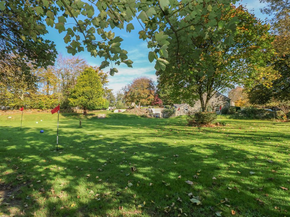 A garden with trees and golf flags at Rafters Cottage Clarbeston Road