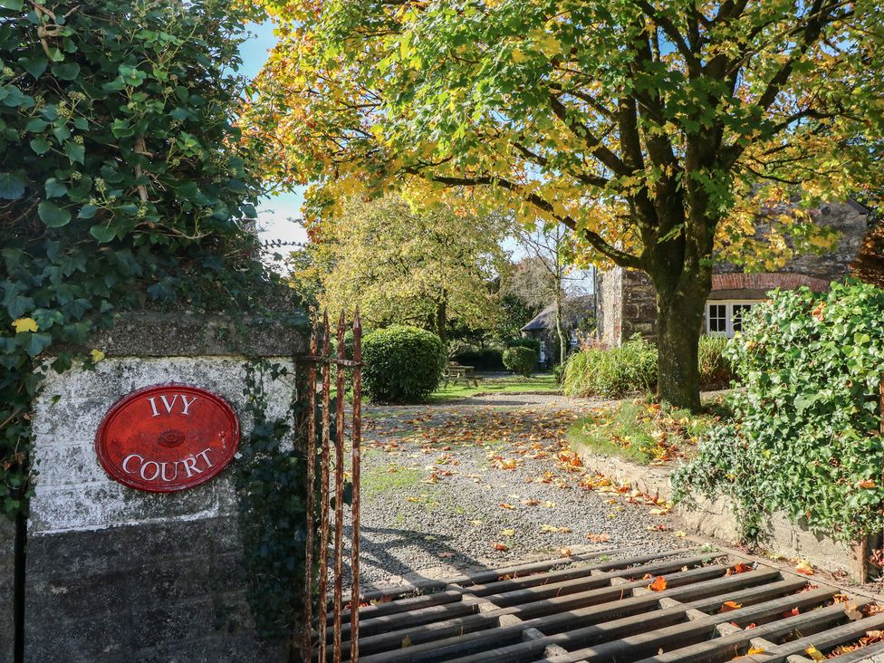 A garden pathway with a sign at Ivy Court in Clarbeston Road