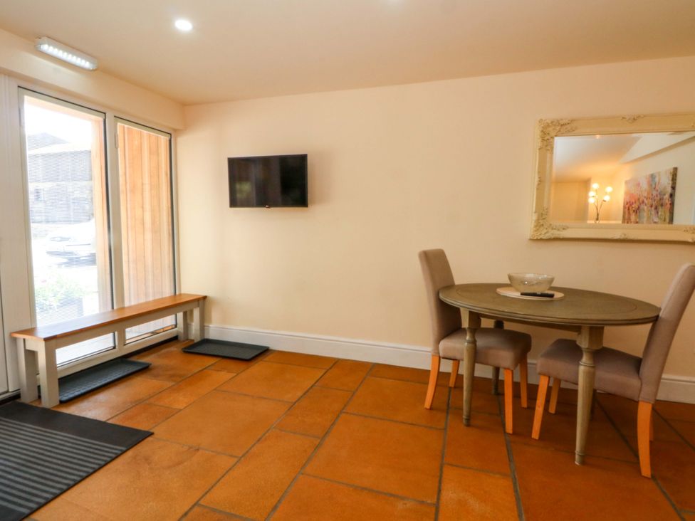 A dining room with a table and chairs at The Old Shippon in 