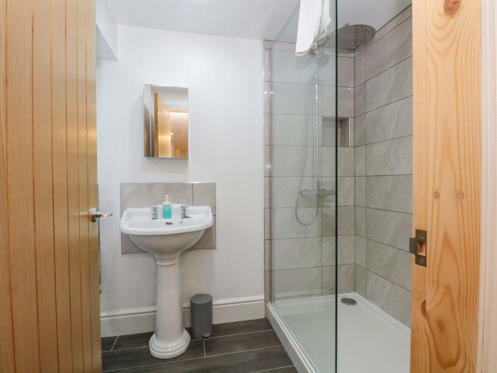 A bathroom with shower and sink at The Old Shippon